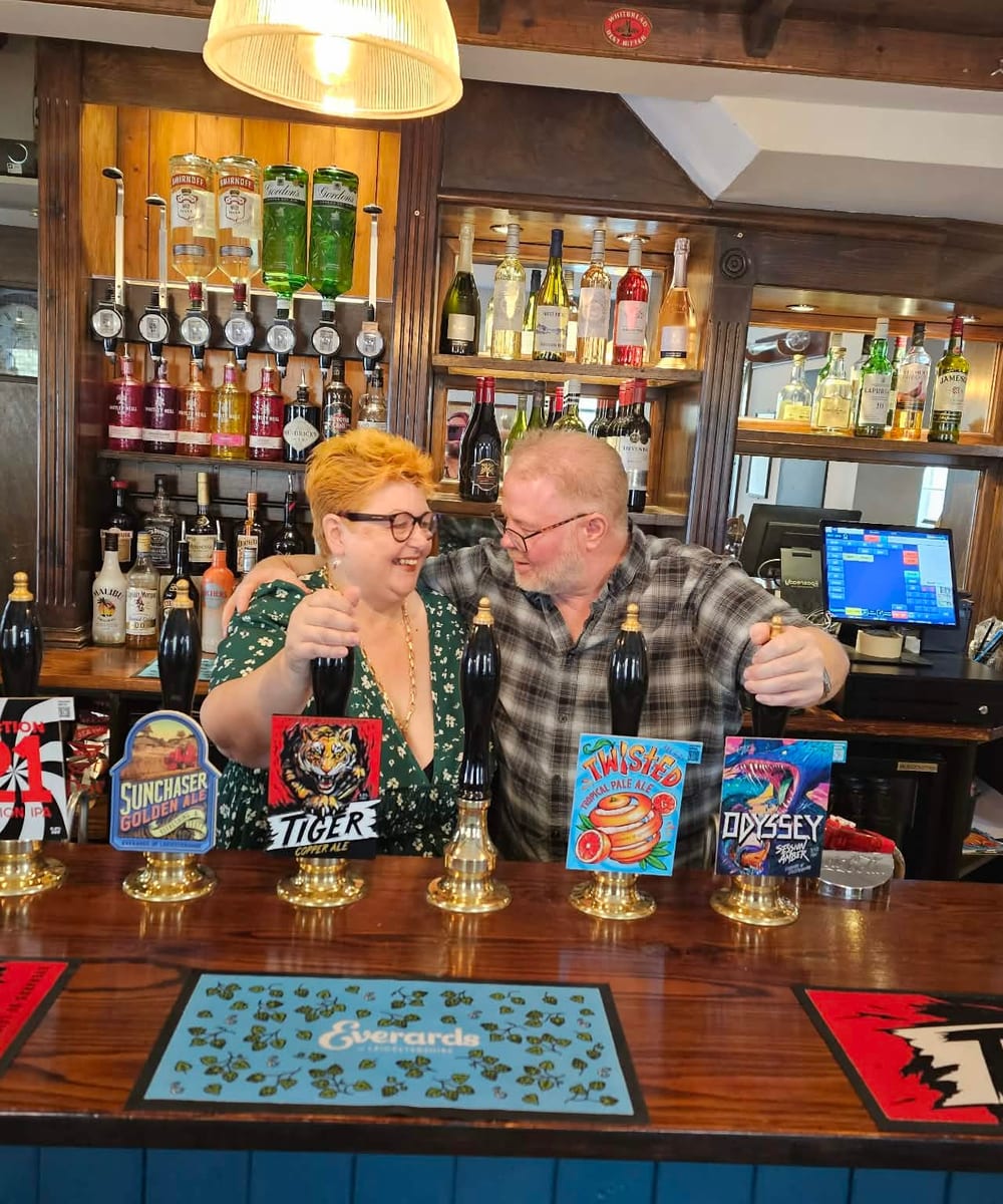Cask ale being poured at a pub bar